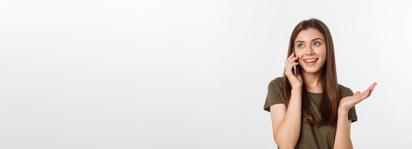 laughing woman talking and texting on the phone isolated on a white background.